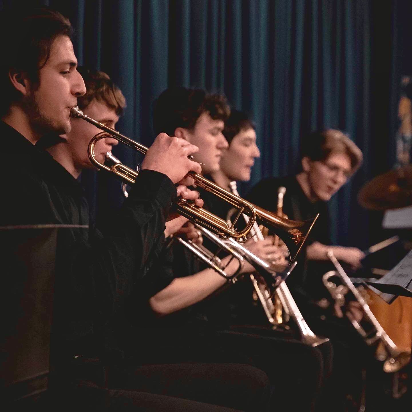Jonathan Parapadakis playing trumpet with mutes with a big band jazz band