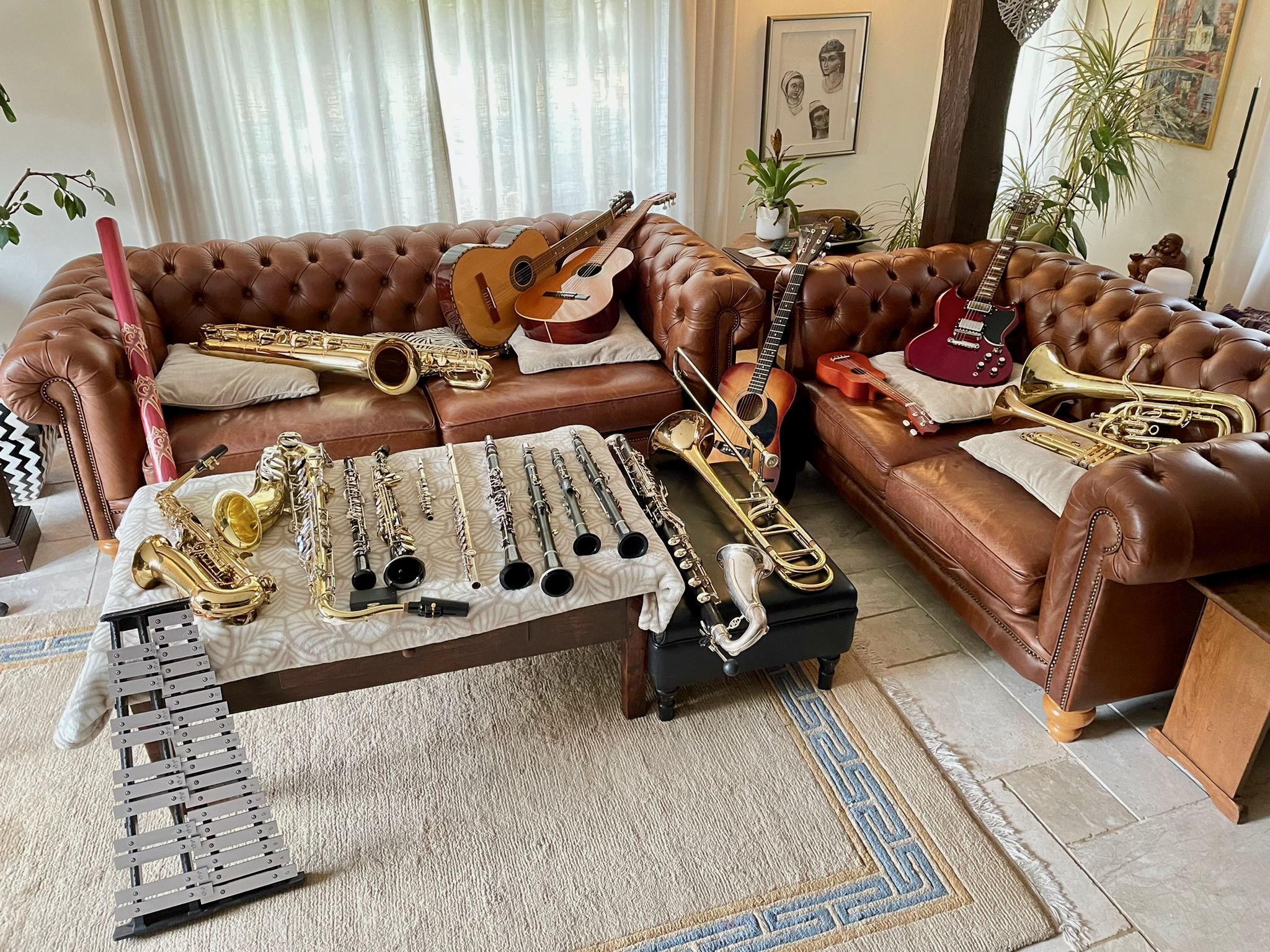 Jonathan Parapadakis instrument collection: guitars, baritone horn, trumpet, trombone, bass clarinet, Bb clarinets, Eb Clarinet, A Clarinet, Flute, Piccolo, Soprano Saxophone, Oboe, Tenor Saxophone, Alto Saxophone, glockenspiel, Baritone Saxophone, didgeridoo