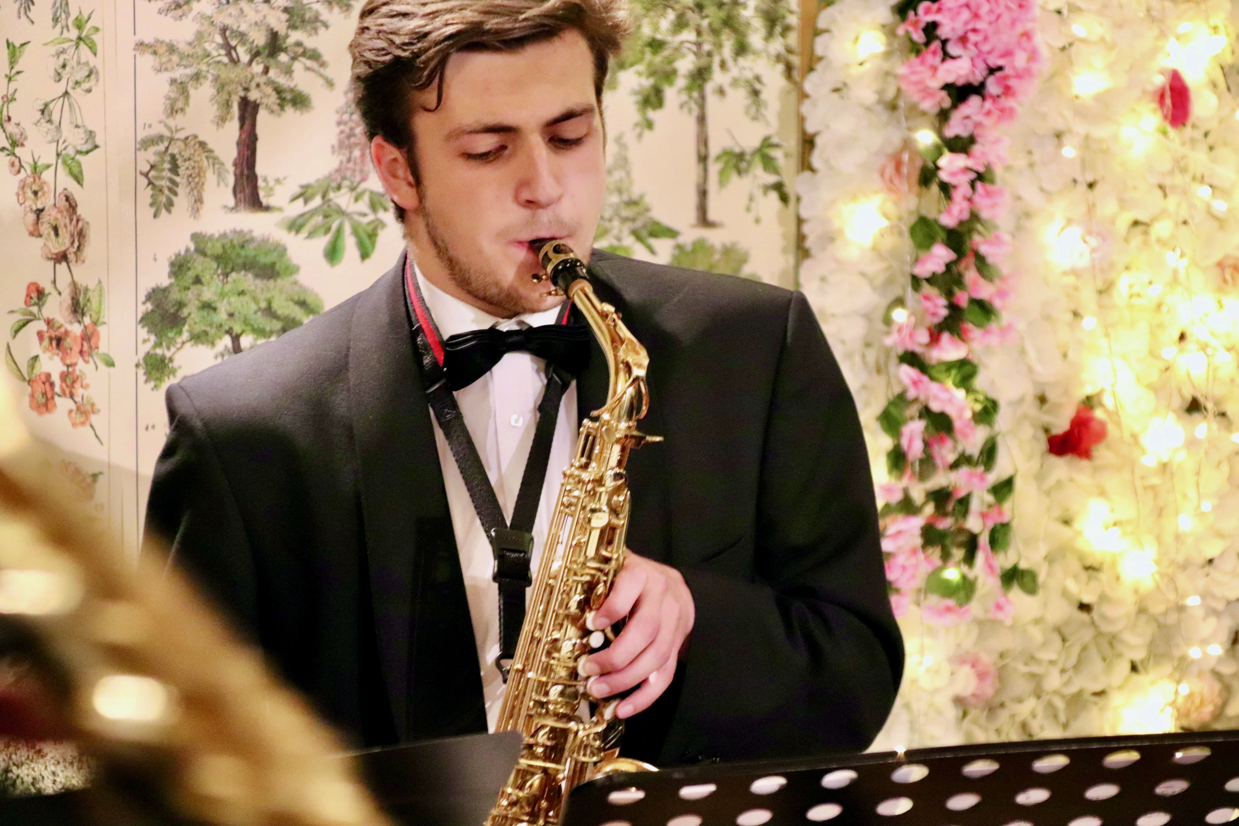 Jonathan Parapadakis playing alto saxophone with a classical saxophone quartet (soprano, alto, tenor, baritone)