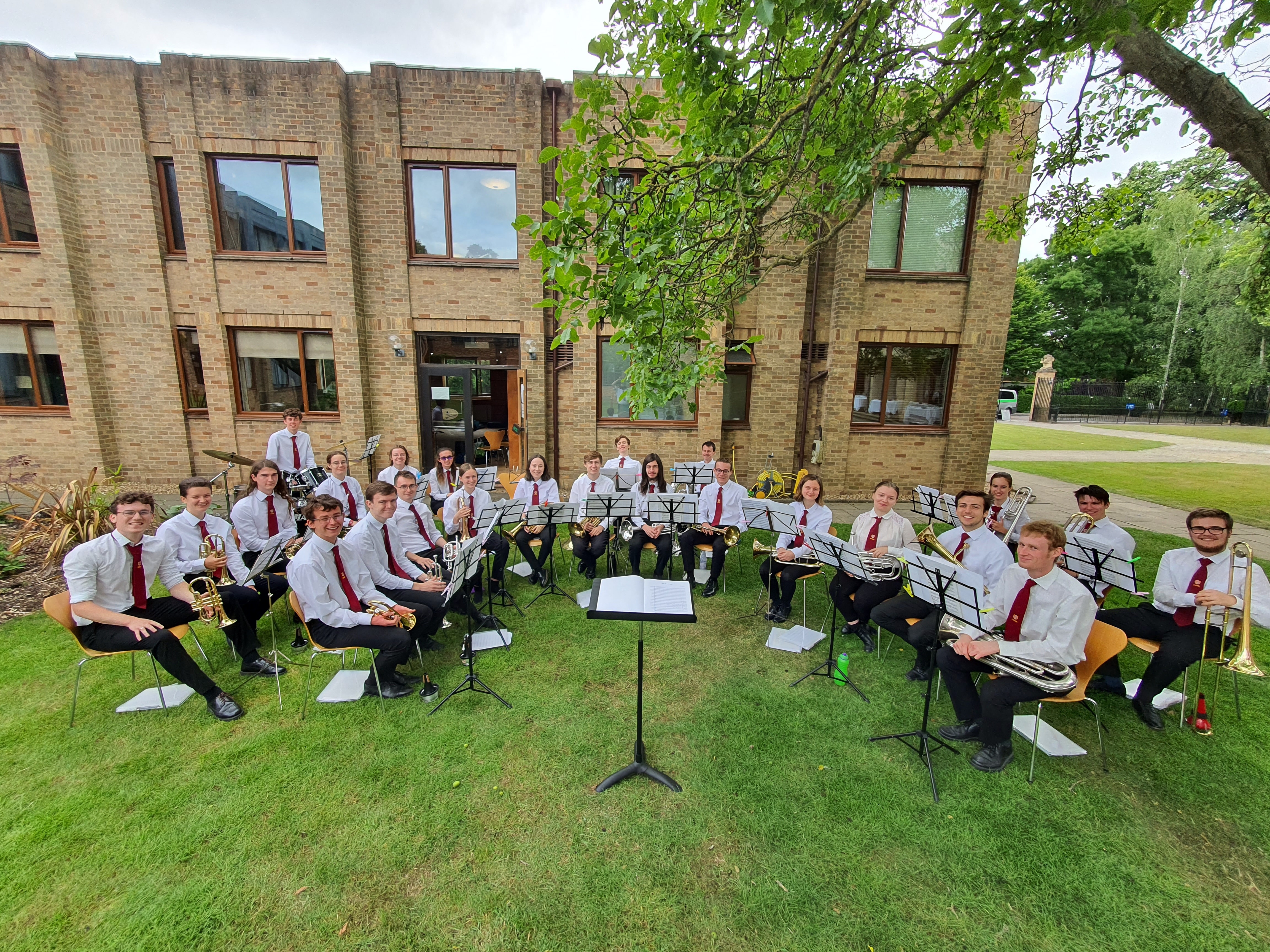 Jonathan Parapadakis playing baritone horn with a brass band. Also pictured are cornets, horns, euphoniums, trombones, tubas, drums